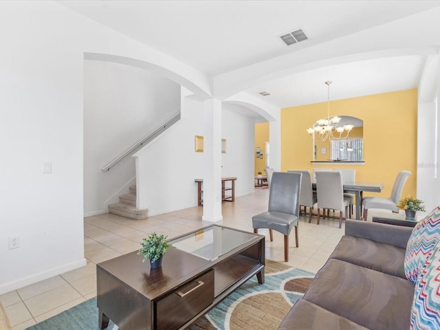 411 Cabello Dr, Davenport, FL 33837 - living room with arched walkways, a notable chandelier, visible vents, and light tile patterned floors