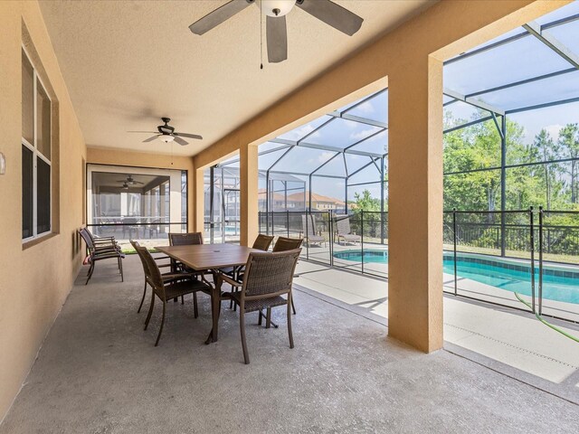 411 Cabello Dr, Davenport, FL 33837 - sunroom / solarium featuring a swimming pool, outdoor dining space, ceiling fan, and a wealth of natural light