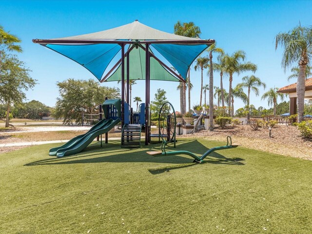 411 Cabello Dr, Davenport, FL 33837 - community jungle gym featuring a lawn