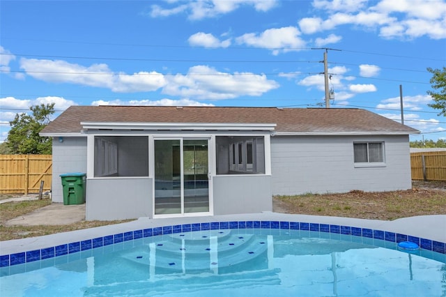 2763 E Waco Dr, Deltona, FL 32738 - back of house featuring a sunroom, roof with shingles, and concrete block siding