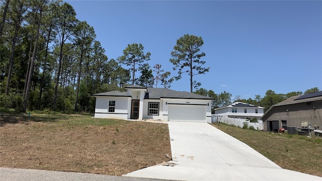 view of front of home featuring a garage, a front lawn, stucco siding, and driveway