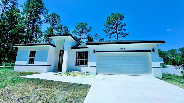 7868 N Hale Rd, Citrus Springs, FL 34434 - view of front of property featuring stucco siding, a garage, concrete driveway, and a front lawn