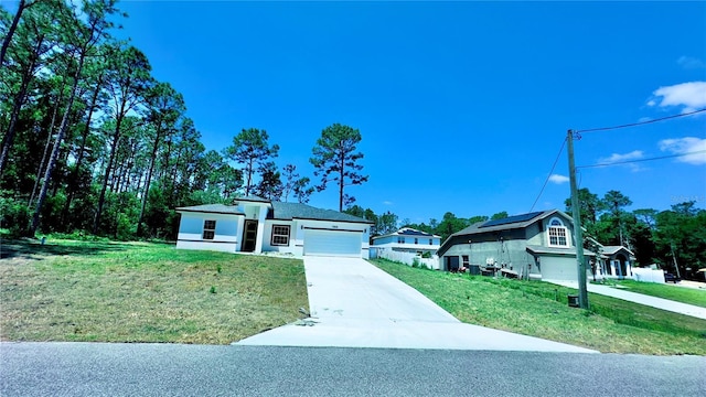 7868 N Hale Rd, Citrus Springs, FL 34434 - view of front of home with a front lawn, concrete driveway, and a garage
