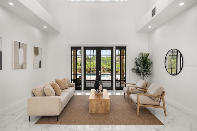 living area with marble tiled flooring, french doors, recessed lighting, plenty of natural light, and a high ceiling
