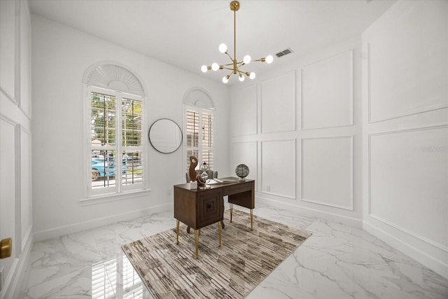office area with light marble finish flooring, a decorative wall, a chandelier, and baseboards