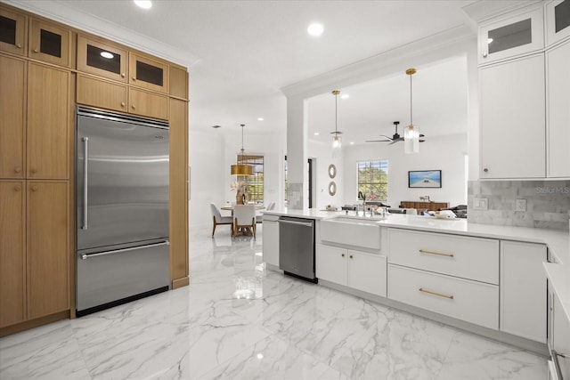 kitchen with stainless steel appliances, recessed lighting, backsplash, light countertops, and glass insert cabinets