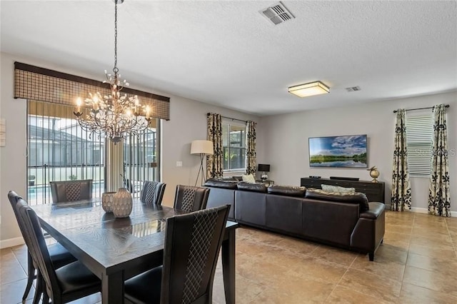 1425 Thunderbird Rd, Davenport, FL 33896 - dining room with visible vents, baseboards, a textured ceiling, light tile patterned floors, and a notable chandelier