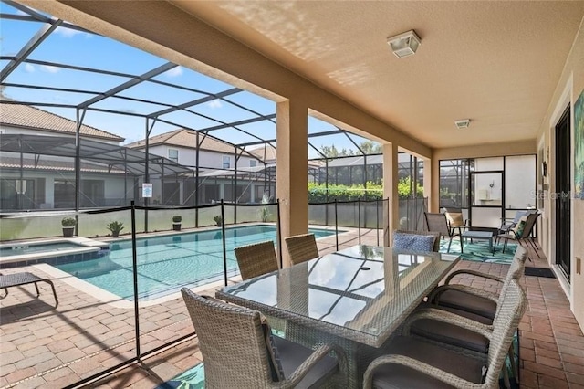 1425 Thunderbird Rd, Davenport, FL 33896 - view of swimming pool featuring a lanai, a patio, a pool with connected hot tub, and outdoor dining space