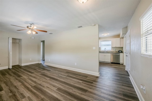 72 Campus View Dr, Orlando, FL 32810 - unfurnished living room with a ceiling fan, dark wood-style flooring, visible vents, a sink, and baseboards