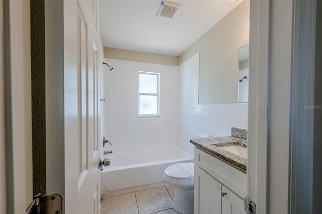 72 Campus View Dr, Orlando, FL 32810 - bathroom featuring tile patterned flooring, vanity, toilet, tile walls, and shower / washtub combination