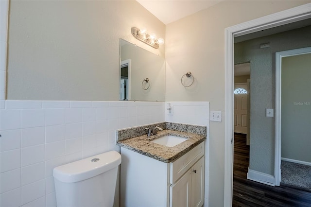 72 Campus View Dr, Orlando, FL 32810 - half bathroom with vanity, wood finished floors, toilet, tile walls, and baseboards