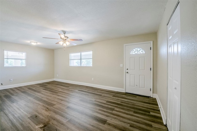 72 Campus View Dr, Orlando, FL 32810 - entrance foyer with baseboards, ceiling fan, dark wood-style flooring, and a textured ceiling