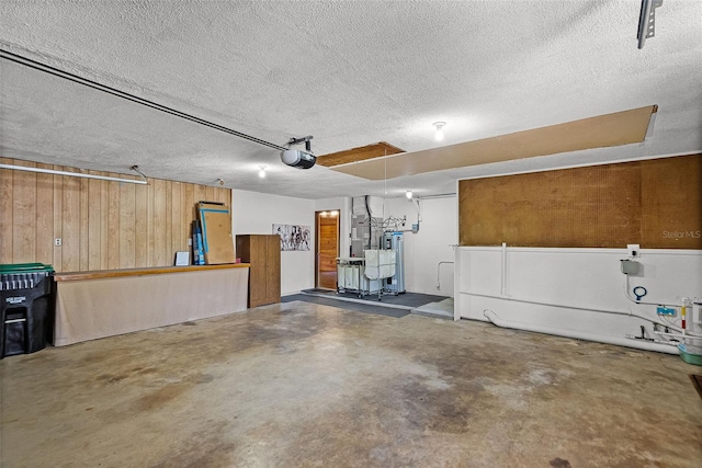 garage with wooden walls and a garage door opener