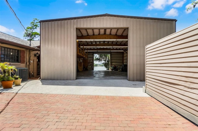 garage featuring decorative driveway and central AC unit