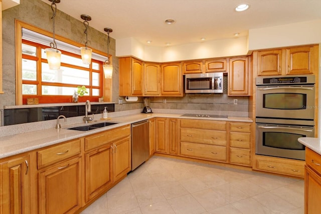 kitchen featuring light tile patterned floors, stainless steel appliances, light countertops, a sink, and pendant lighting