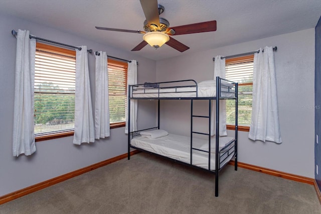 unfurnished bedroom featuring baseboards, a ceiling fan, and carpet floors