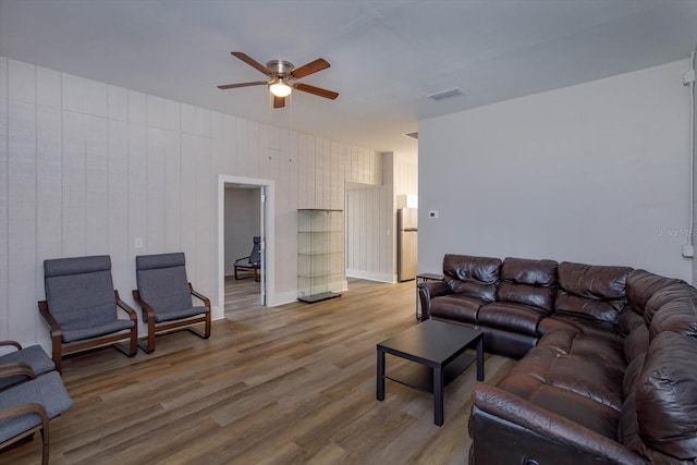 living room featuring visible vents, ceiling fan, and light wood-style floors