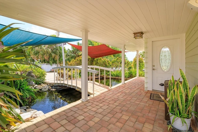 view of dock with fence and a garden pond