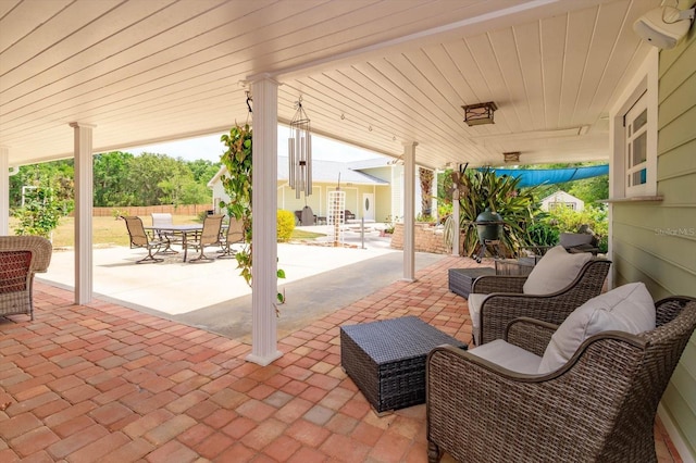 view of patio featuring outdoor dining space and fence