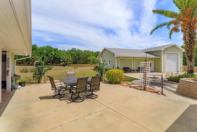 view of patio with outdoor dining area and fence