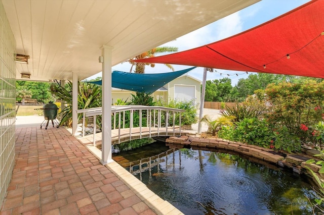 36408 E Eldorado Lake Dr, Eustis, FL 32736 - view of patio with a small pond