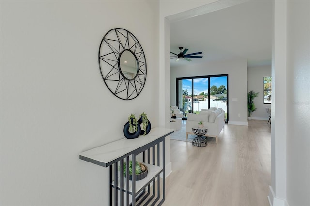 hallway with baseboards and light wood-style floors