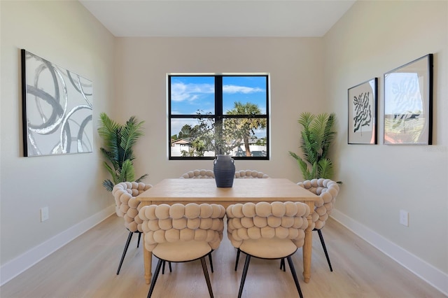 dining room with baseboards and light wood-style floors
