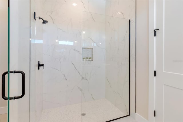full bathroom with a marble finish shower