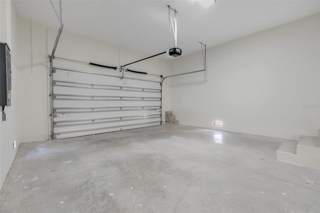 garage with a garage door opener and electric panel