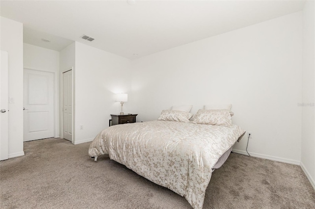 carpeted bedroom featuring visible vents and baseboards