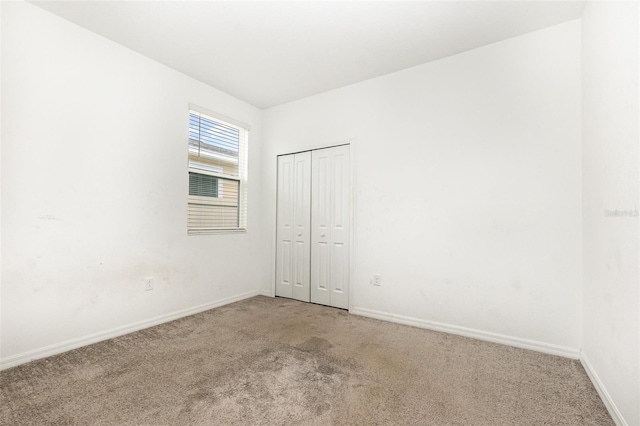 empty room with carpet flooring and baseboards