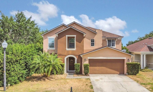 view of front of house featuring stucco siding, driveway, and an attached garage