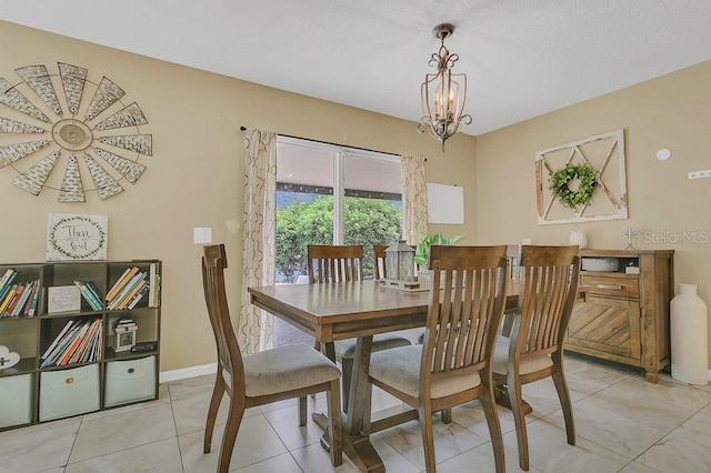 dining space with a notable chandelier and baseboards