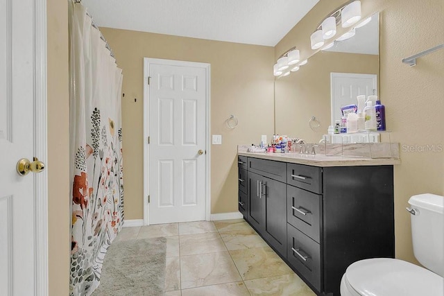 bathroom featuring toilet, tile patterned floors, curtained shower, and vanity
