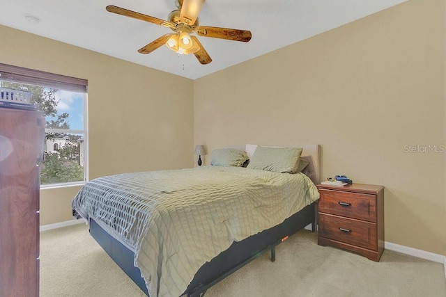bedroom with baseboards, a ceiling fan, and carpet floors
