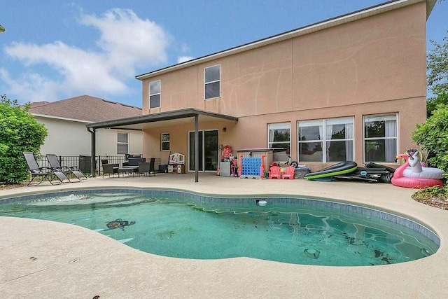 view of swimming pool featuring fence, a patio, and a fenced in pool