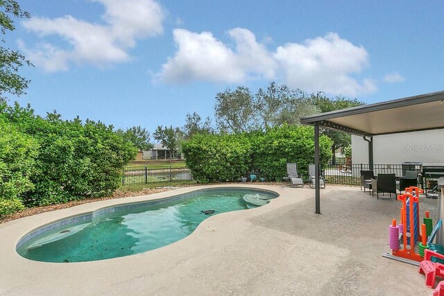 view of pool with a fenced in pool, a patio area, and a fenced backyard