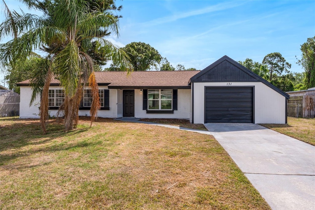 131 Manth Ave, Cocoa, FL 32927 - single story home with fence, concrete driveway, a front yard, and an attached garage