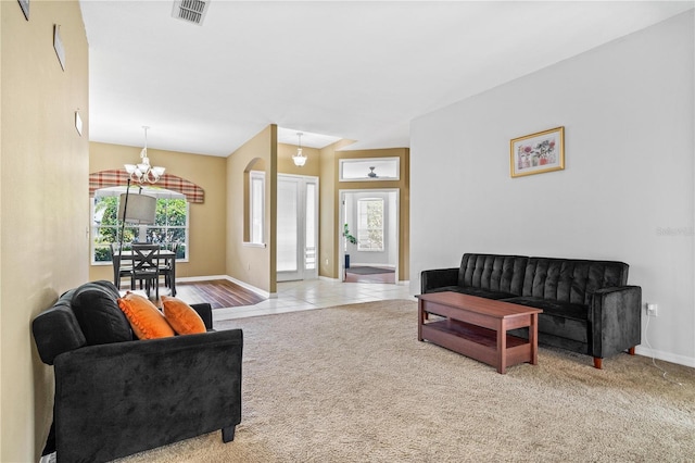 living area featuring baseboards, visible vents, an inviting chandelier, and carpet flooring