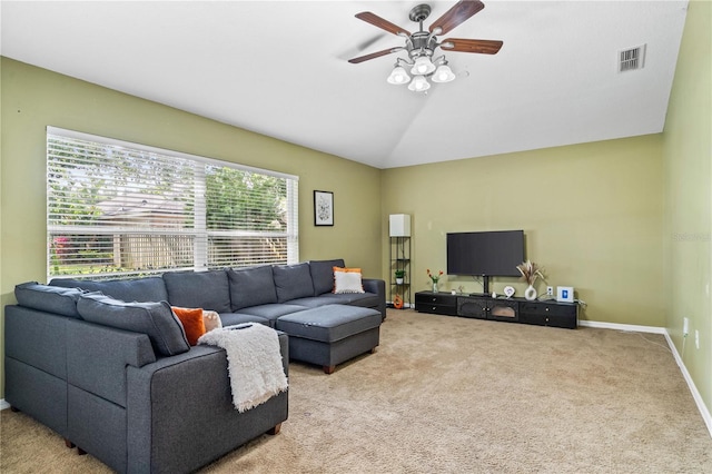 living area with carpet flooring, ceiling fan, visible vents, baseboards, and lofted ceiling