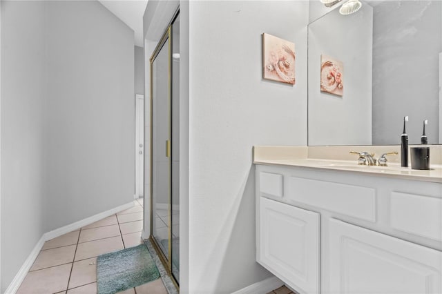 full bath with vanity, tile patterned flooring, a stall shower, and baseboards