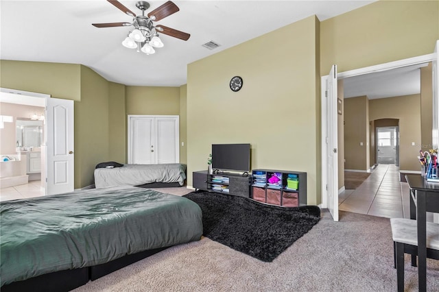 bedroom with lofted ceiling, visible vents, baseboards, tile patterned floors, and carpet