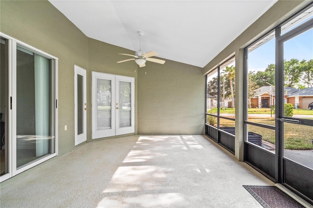 unfurnished sunroom with a ceiling fan and french doors