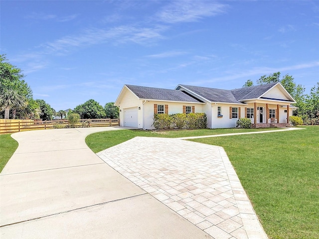 view of front of house with a front lawn, a garage, decorative driveway, stucco siding, and fence