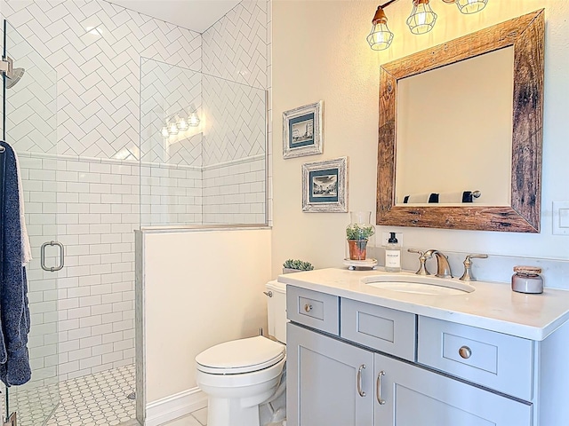 bathroom featuring toilet, vanity, and a shower stall
