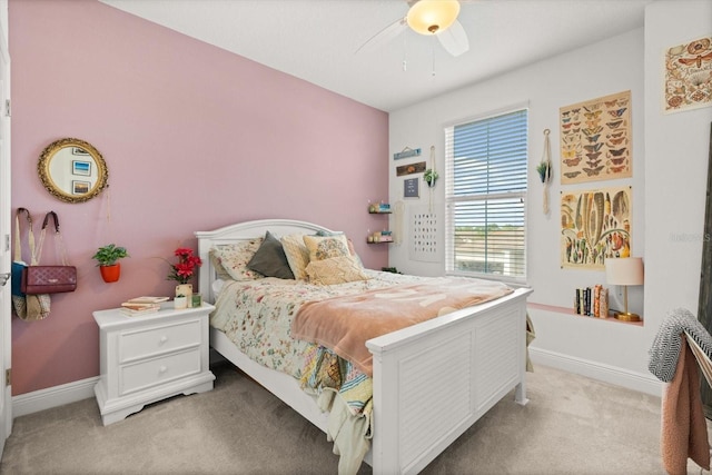 carpeted bedroom with ceiling fan and baseboards