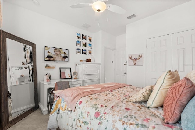 bedroom with light carpet, a closet, ceiling fan, and baseboards