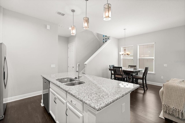 kitchen with a sink, baseboards, stainless steel appliances, and dark wood-type flooring