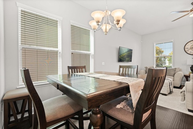 dining space with a chandelier, a ceiling fan, and dark wood-style floors