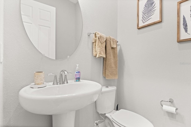 half bathroom featuring toilet